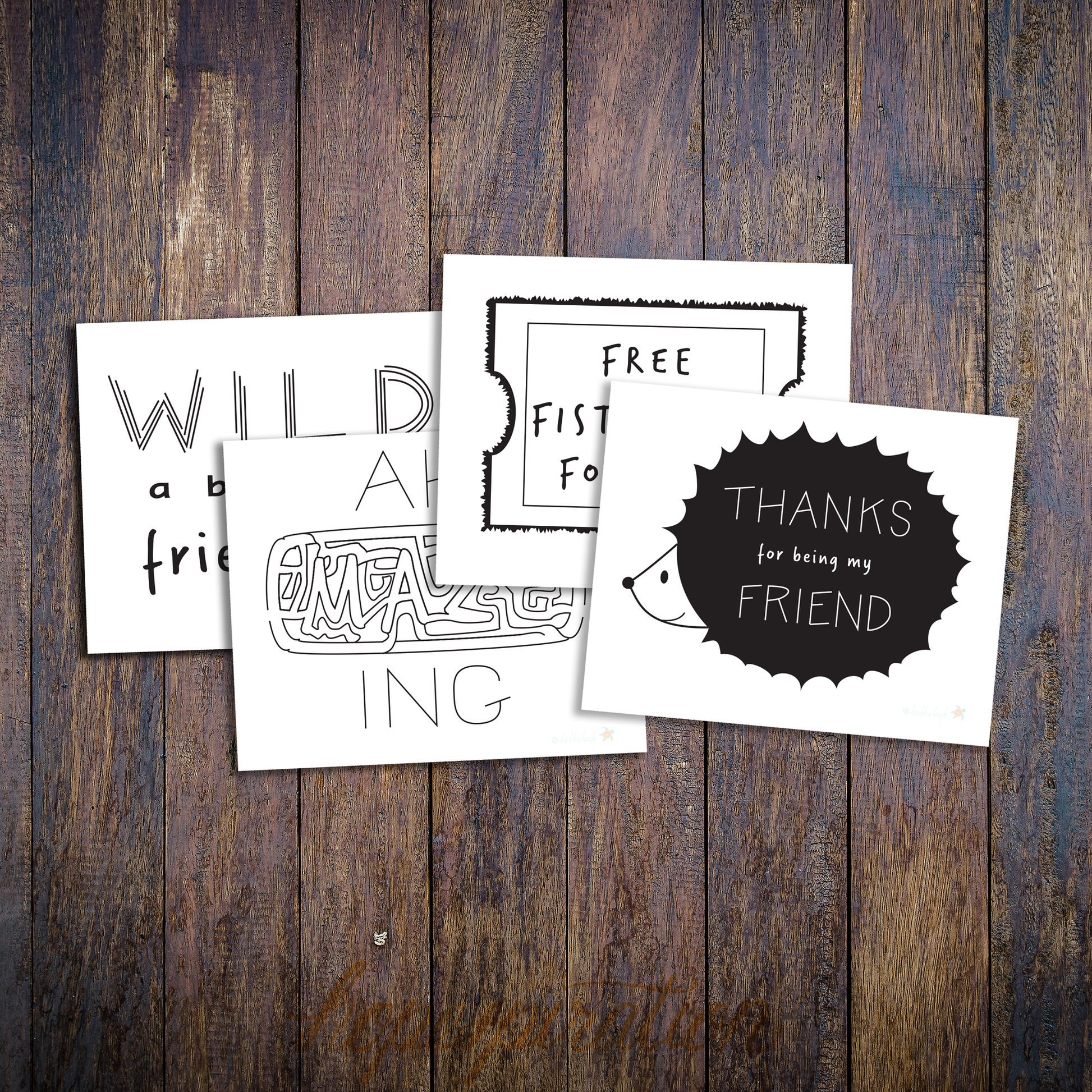 Layout of four friendship cards, in black and white on wood background.